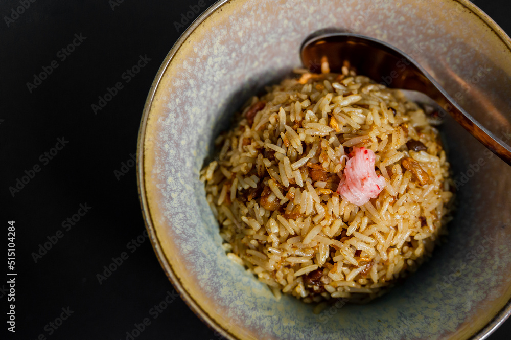 close up of a beef fried rice in a plate on a table close up of a beef fried rice in a plate on a table