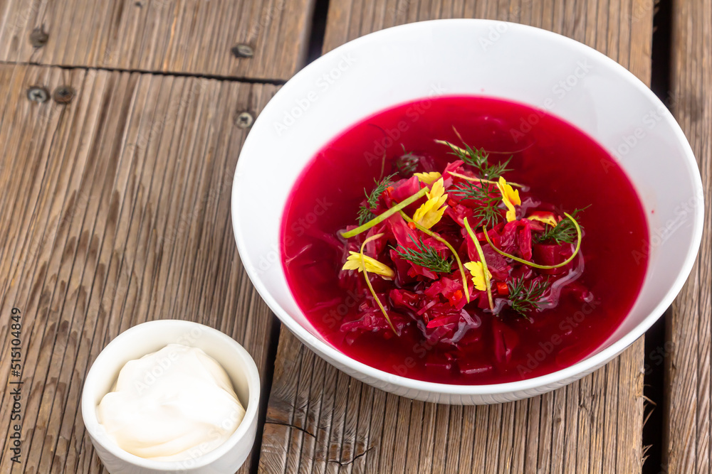 Vegetable cold soup with beet, cucumber, radsih and egg on wooden table Vegetable cold soup with beet, cucumber, radsih and egg on wooden table