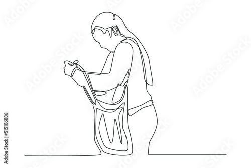 One continuous line drawing of woman checking her shopping bag. Shopping Mall concept. Single line draw design vector graphic illustration.