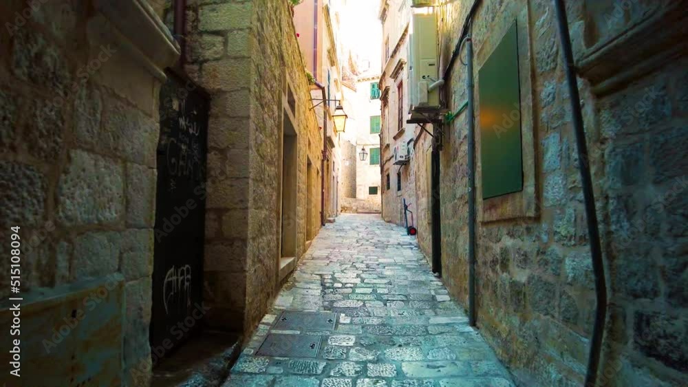 Handheld shot of the famous narrow alley of Dubrovnik in the old town, Croatia. Ancient and narrow path with stone architecture. A UNESCO World Heritage Site. A famous tourist destination. 4K UHD Handheld shot of the famous narrow alley of Dubrovnik in the old town, Croatia. Ancient and narrow path with stone architecture. A UNESCO World Heritage Site. A famous tourist destination. 4K UHD