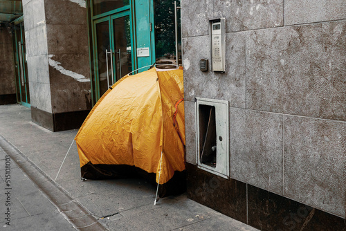 Photography Yellow tent in town center for homeless