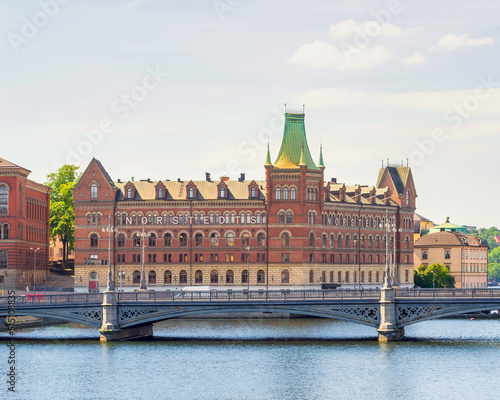 Norstedt Building, or Norstedtshuset, overlooking The Vasa Bridge, or Vasabron, located in central Stockholm, in a summer sunny day. The bridge connects Norrmalm to Gamla stan, Stockholm, Sweden photo