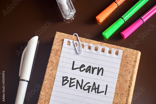 Learn Bengali text is shown on a piece of paper on study desk. Learning new language concept.