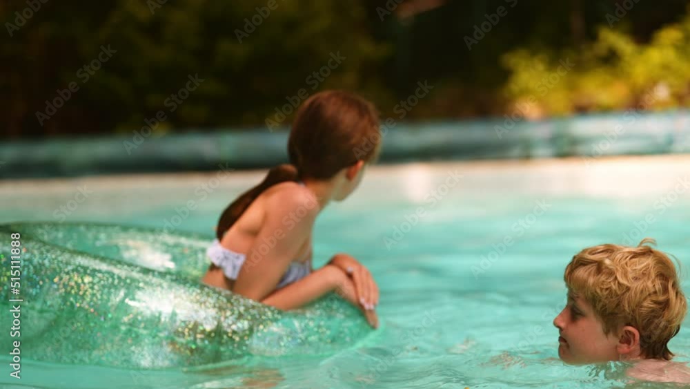 Two Kids Boy and Girl Resting in the Pool. Summer Vacation Concept Two Kids Boy and Girl Resting in the Pool. Summer Vacation Concept