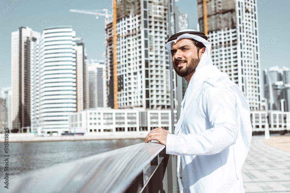 Arabic businessman looking at the skyline in Dubai Arabic businessman looking at the skyline in Dubai