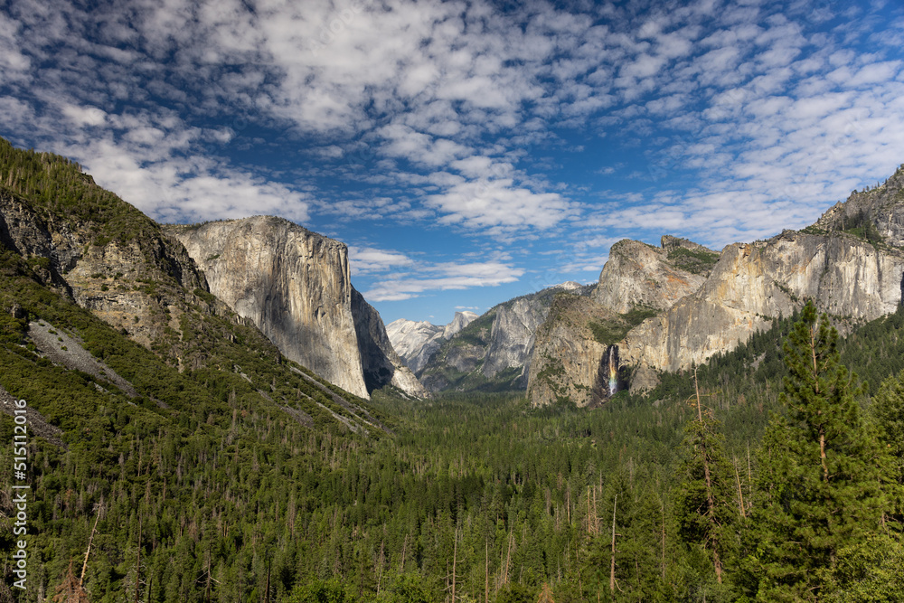 Scenic view of famous Yosemite tunnel view valley with rainbow waterfall on a beautiful sunny day with blue sky in summer, Yosemite National Park, California, USA