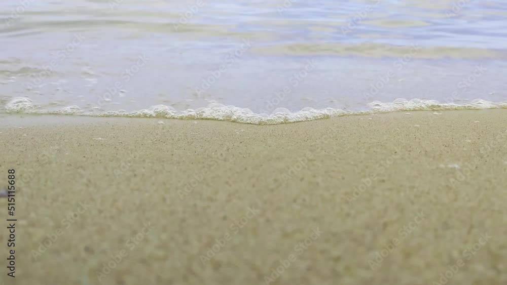 Waves of the sea or ocean roll on the sandy shore. Relax on the beach on a sunny summer day. Vacation at sea. Nature background Waves of the sea or ocean roll on the sandy shore. Relax on the beach on a sunny summer day. Vacation at sea. Nature background