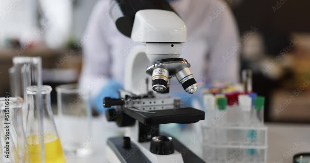 Scientist medical examine samples under microscope Scientist medical examine samples under microscope