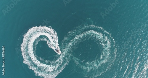 Aerial top view of a white pleasure boat on a summer day. Powerboat turn loop eight on the sea making metaverse infinity future concept.  © .shock