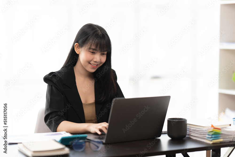 Portrait of Asian young female working on laptop at office Portrait of Asian young female working on laptop at office