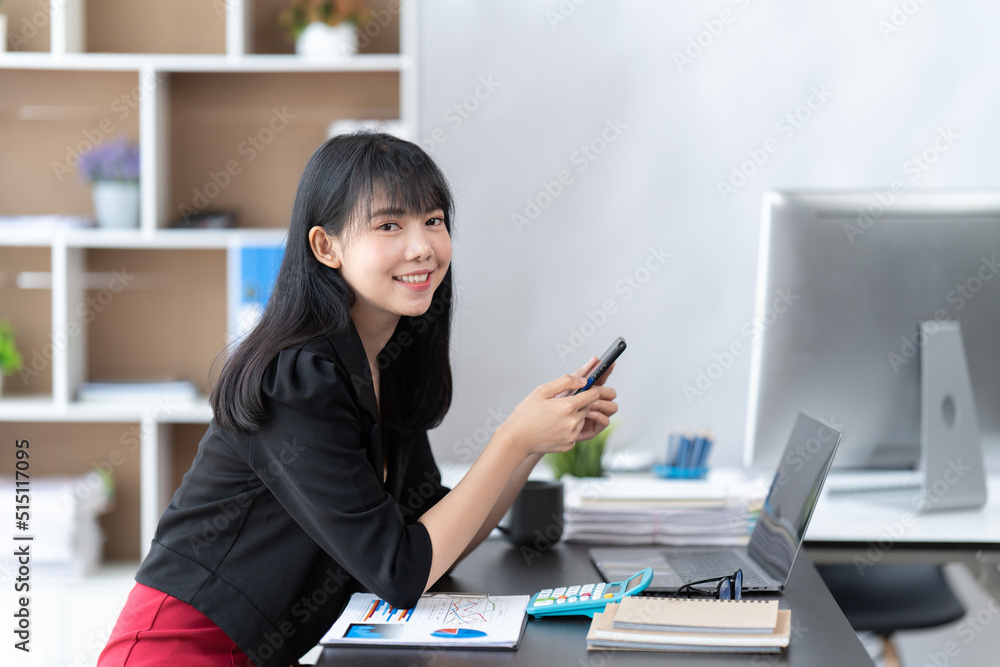 Asian businesswoman in formal suit in office happy and cheerful during using smartphone and working. Asian businesswoman in formal suit in office happy and cheerful during using smartphone and working.