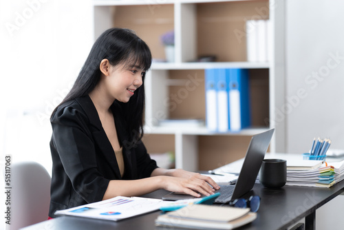 Portrait of Asian young female working on laptop at office