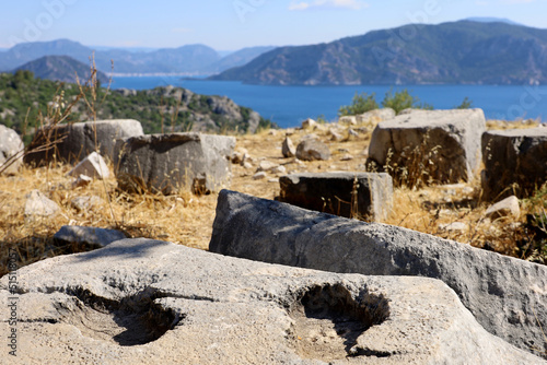 Stone ruins of ancient Amos town in Turkey founded by the Dorians in the VII century BC. View to amphitheater and Mediterranean sea