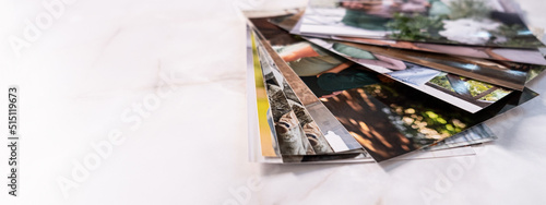 Photos woman sitting at desk and looking at printed photos, remember nostalgia for a day of rest