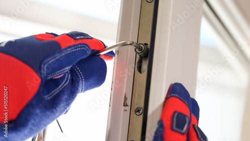Master in gloves adjusting locks of pvc windows with special key