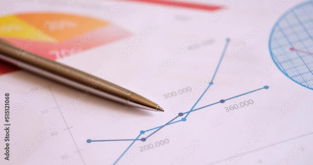 Analysis of financial reports and linear statistical charts closeup Analysis of financial reports and linear statistical charts closeup