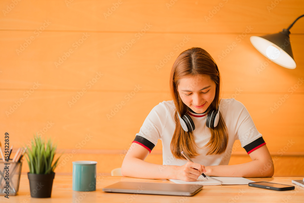 Asian young woman working with laptop computer and financial documents at home online study and work concept Asian young woman working with laptop computer and financial documents at home online study and work concept