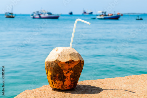 Coconut juice with blue water a background
