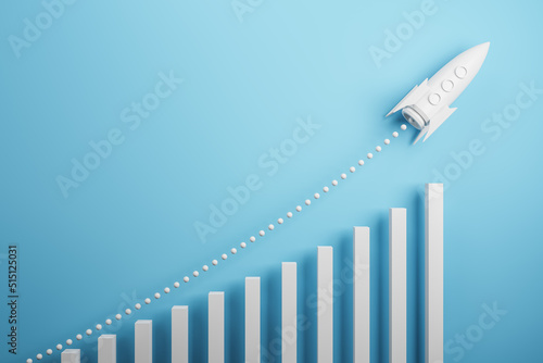 Startup and new project concept with white rocket flying up with dotted trajectory above light growth graph on blue background. 3D rendering