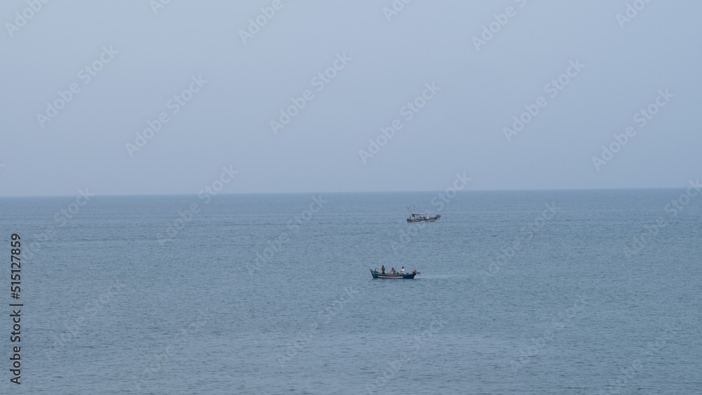 Two fishing boats in the middle of a calm ocean