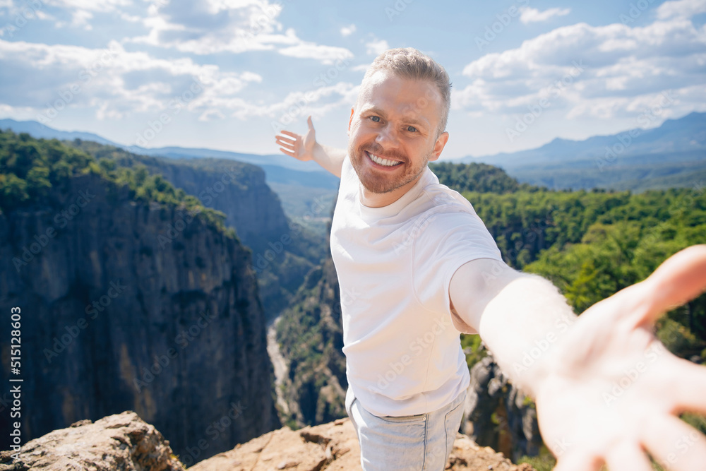 Naklejka premium Happy man tourist make selfie photo background of sunset in mountain Tazi canyon in Manavgat Antalya Turkey