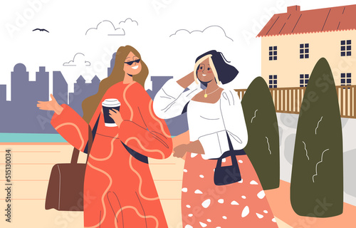 Two young women walk on sea embankment drink coffee talk. Girls on summer vacation enjoy seafront