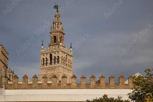 Top of the giralda of Seville seen from inside the orange tree courtyard. Concept monuments, travel, culture, cathedral, Spain.