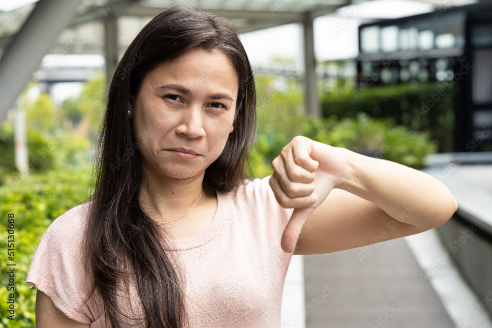 woman showing rejecting thumb down hand gesture