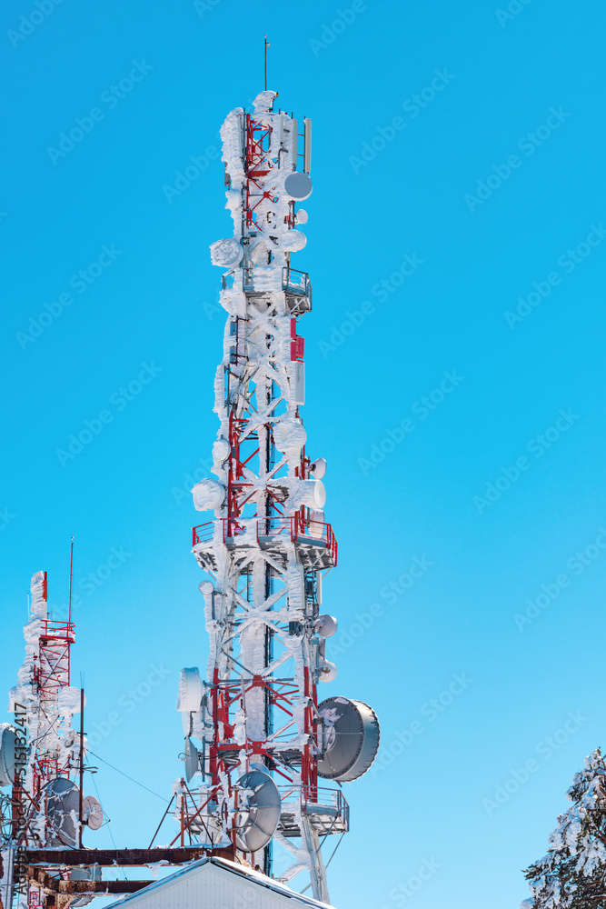 Telecommunication tower covered in snow