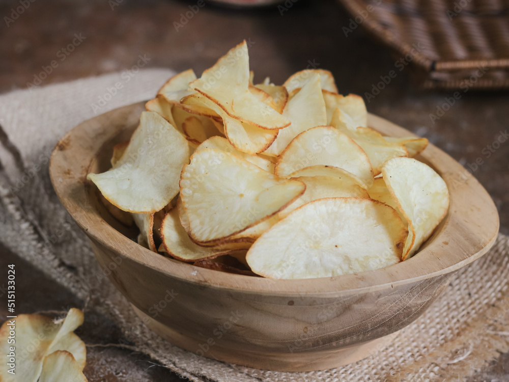 Keripik singkong. Cassava chips or tapioca chips is traditional snack from Java, made of cassava thinly sliced and fried Keripik singkong. Cassava chips or tapioca chips is traditional snack from Java, made of cassava thinly sliced and fried