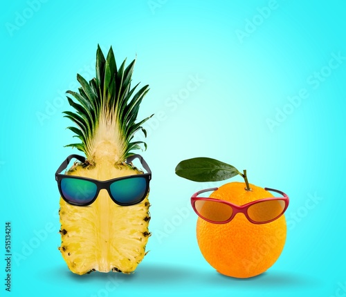 Creative summer pineapple with sunglasses and grapefruit with glasses. Minimal summer concept.