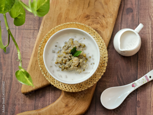 Bubur Kacang Hijau, Indonesian dessert or breakfast made from mung beans cooked in coconut milk and palm sugar flavored with pandan leaves. White textures surface. Selective focus