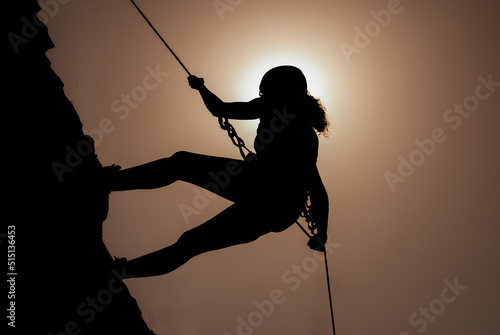 Murais de parede Silhouette of successful young female climber in the mountains Concept of self-improvement, motivation, movement inspiration, motivational goals