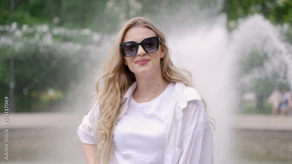 Smiling woman in sunglasses in park Smiling woman in sunglasses in park