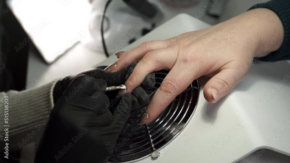 Close up view, manicurist paints woman's nails. A caucasian woman does a manicure in a beauty salon. Nails Care And Manicure Close up view, manicurist paints woman's nails. A caucasian woman does a manicure in a beauty salon. Nails Care And Manicure