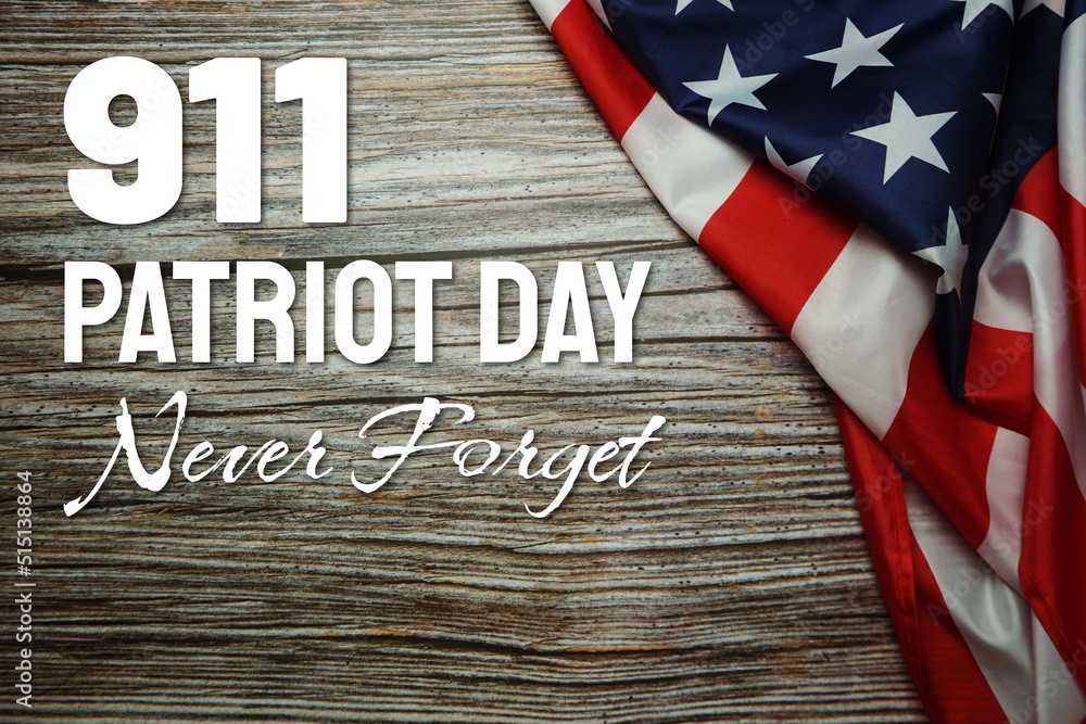 911 We will Never Forget Word with USA flag on wooden background 911 We will Never Forget Word with USA flag on wooden background
