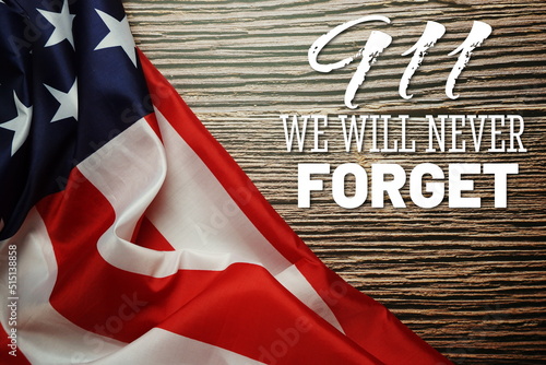 911 We will Never Forget  Word with USA flag on wooden background photo