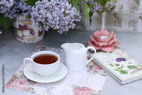 still life with morning cup of tea and lilac flowers
