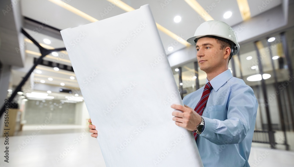 An architect with drawings in his hands. Man supervises construction work. Foreman and construction. An architect with drawings in his hands. Man supervises construction work. Foreman and construction.