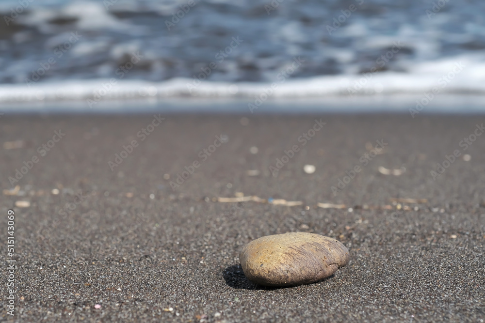 A stone at the famous beach of Perissa in Santorini Greece A stone at the famous beach of Perissa in Santorini Greece