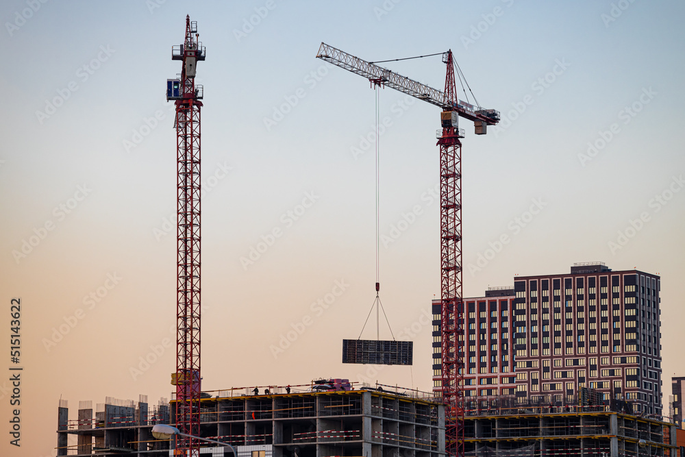  high-rise crane works at a construction site