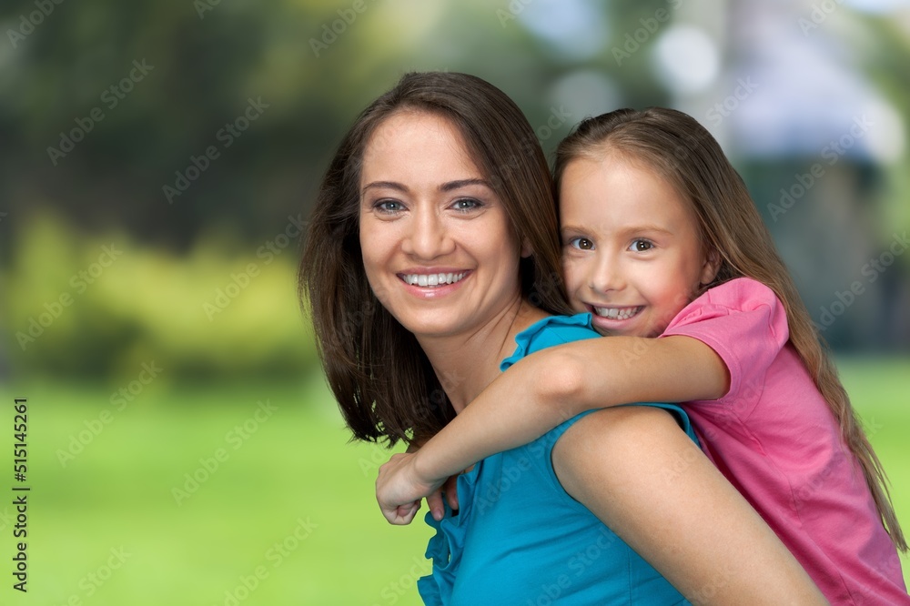 Happy mother having fun with her daughter outdoor