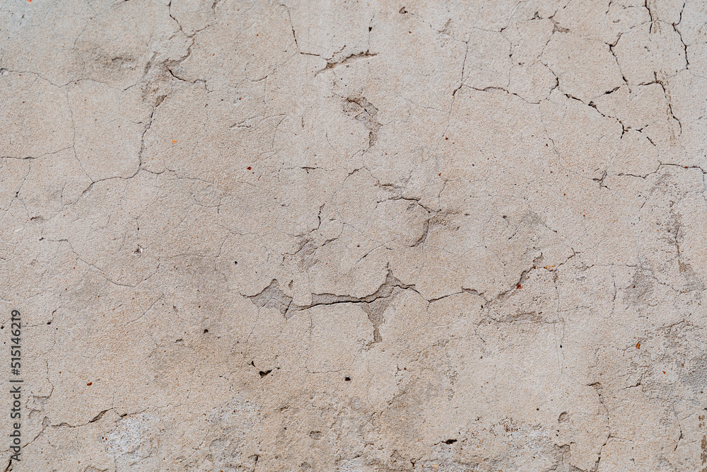 An old shabby wall with cracks. Peeling plaster. Street walls of the old building. Renovation of living quarters. Textured surface, abstract drawing An old shabby wall with cracks. Peeling plaster. Street walls of the old building. Renovation of living quarters. Textured surface, abstract drawing