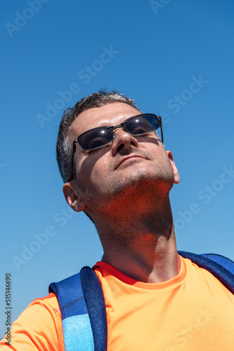 Portrait of a mddle-aged man warming up in the sun 