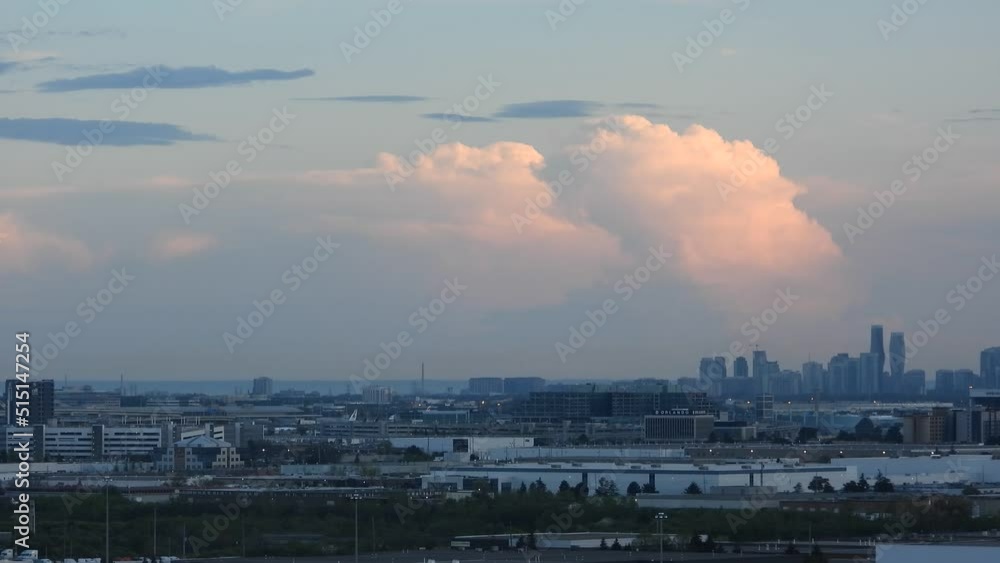 Silhouettes of Toronto city skyscrapers in Canada, panorama of the rising city in the early morning with wandering big clouds - hyperlapse static shot Silhouettes of Toronto city skyscrapers in Canada, panorama of the rising city in the early morning with wandering big clouds - hyperlapse static shot