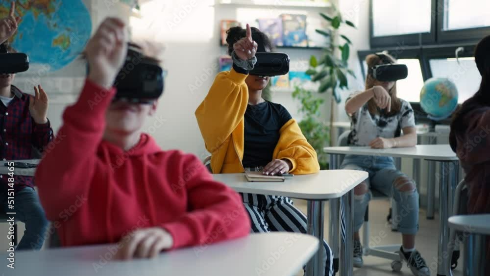 Teenage students wearing virtual reality goggles at school in computer science class Teenage students wearing virtual reality goggles at school in computer science class