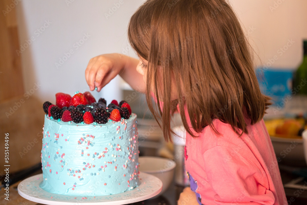 Make a cake at home. Delicious cake with handmade berries. Girl learning to bake a cake Make a cake at home. Delicious cake with handmade berries. Girl learning to bake a cake