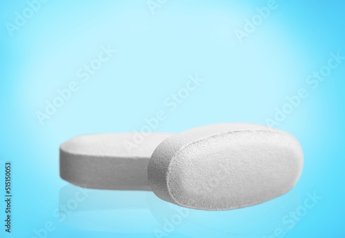 COVID-19 experimental antiviral drug, two white pills on a background photo