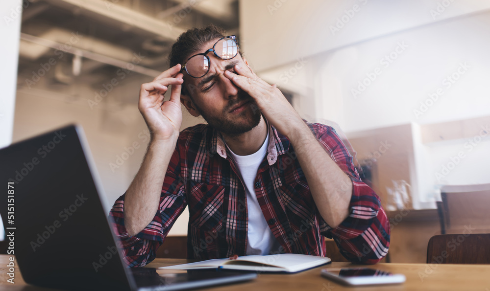 Millennial businessman working at desk in office Millennial businessman working at desk in office