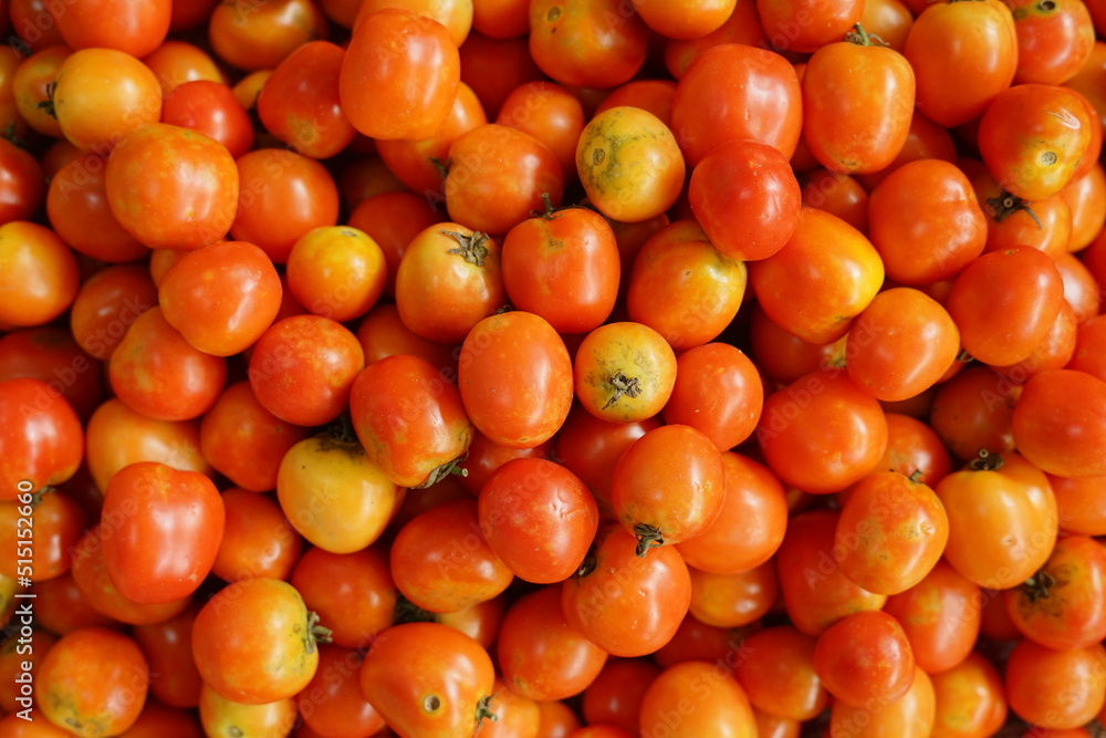 Top view Indonesian tomato fruit at Market Stalltop on the background of a basket with tomatoes. Top view Indonesian tomato fruit at Market Stalltop on the background of a basket with tomatoes.